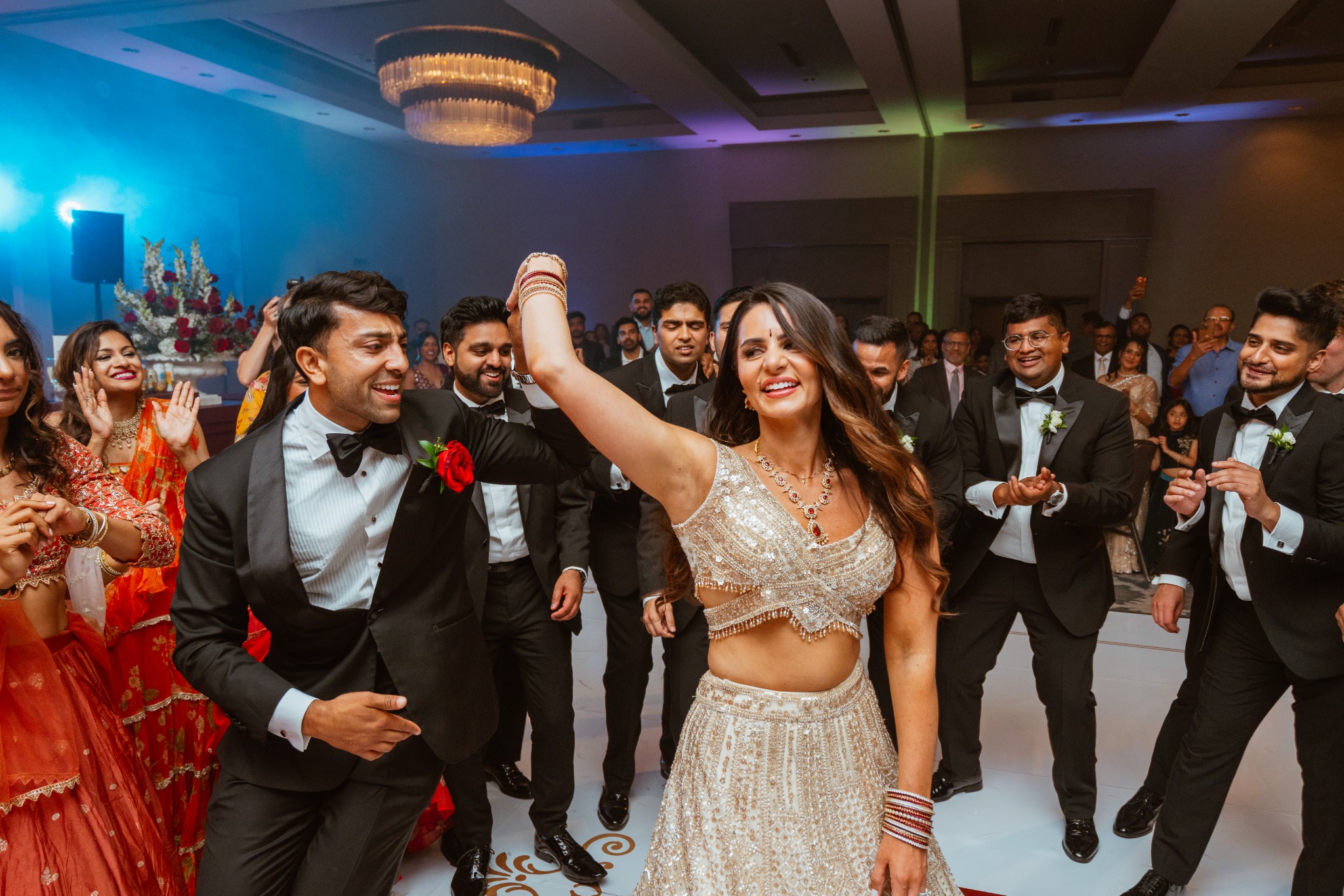 Wedding couple dancing with guests during the reception